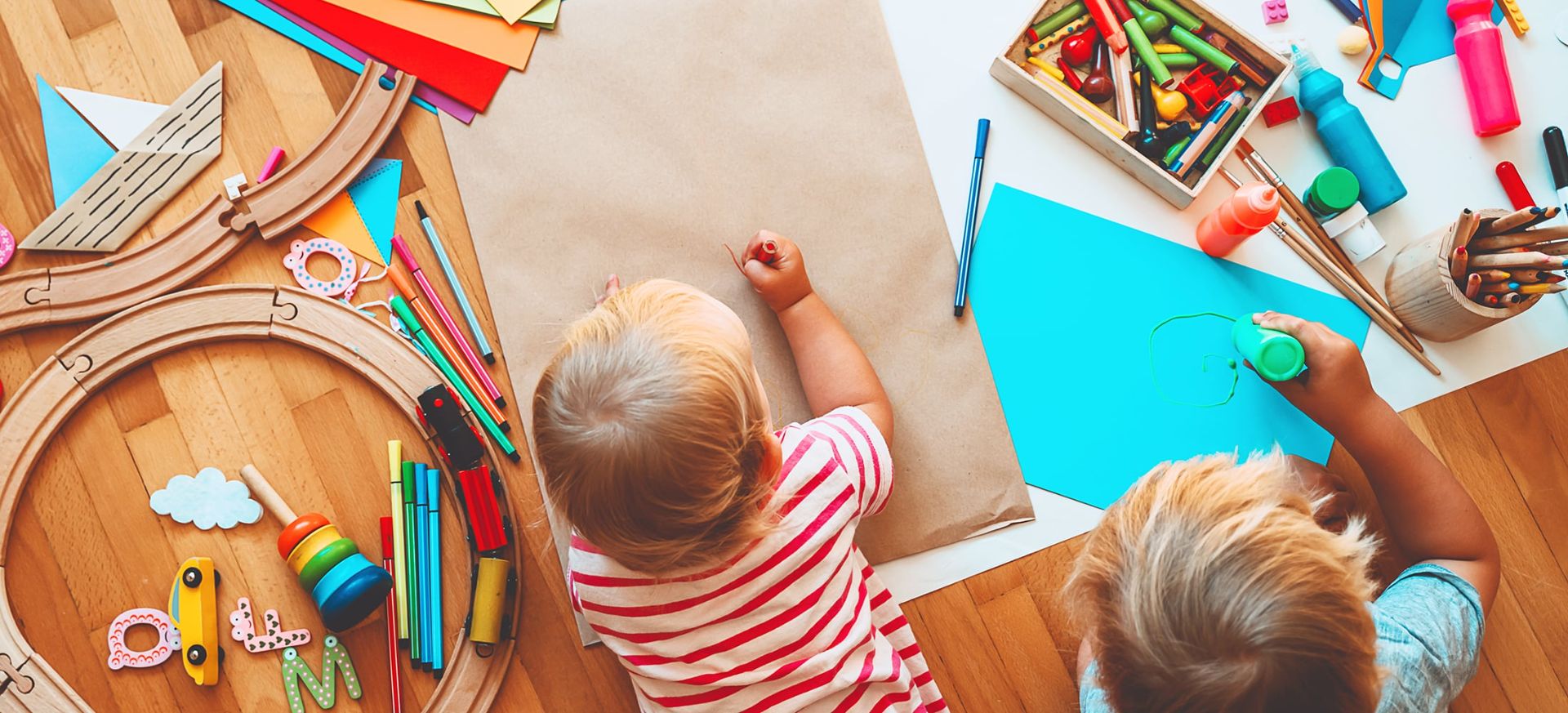 Preschool children drawing and painting with colorful art supplies at The WEE Center in Danville, VA